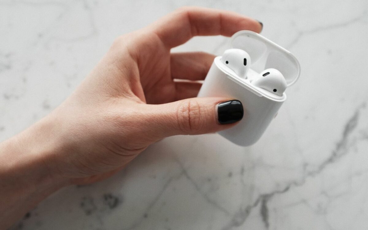 person holding airpods
