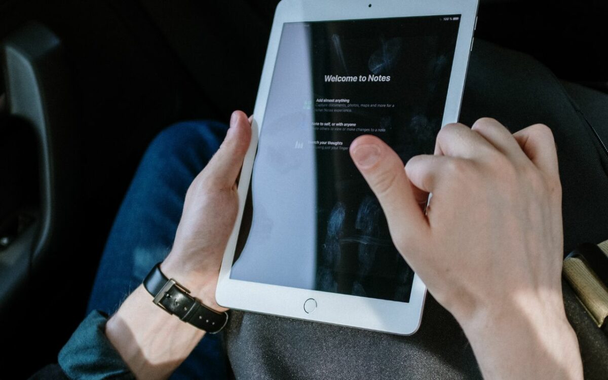 person holding white ipad